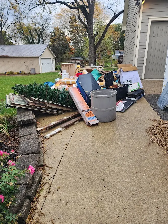 Dumpster being loaded with debris for 12 Yard Dumpster Rental in Elba